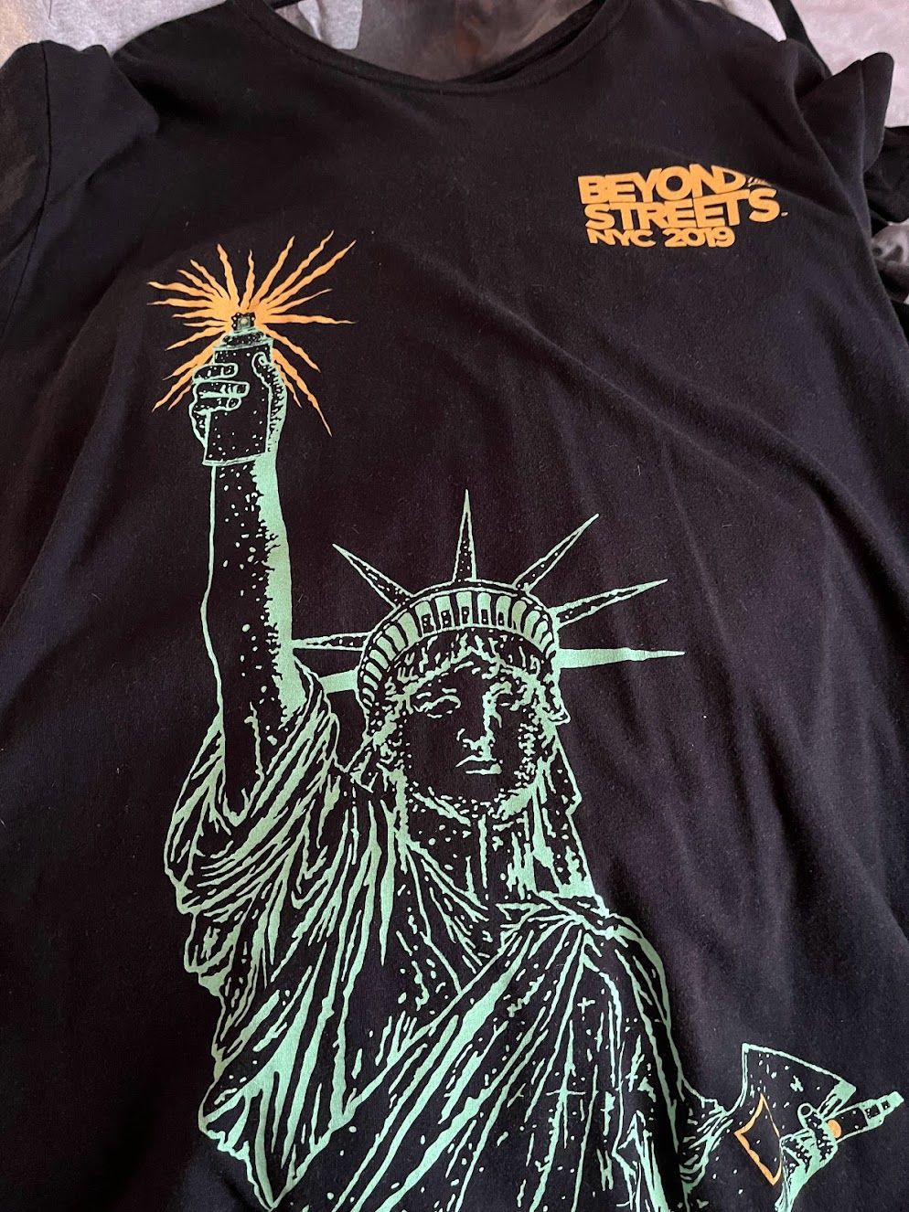 Statue of Liberty in graffiti t-shirt from Beyond the Streets exhibition